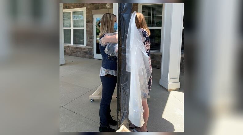 Staffers at a BrightStar Senior Living demonstrate a hugging wall like one to be available at it new facility in Warren County.