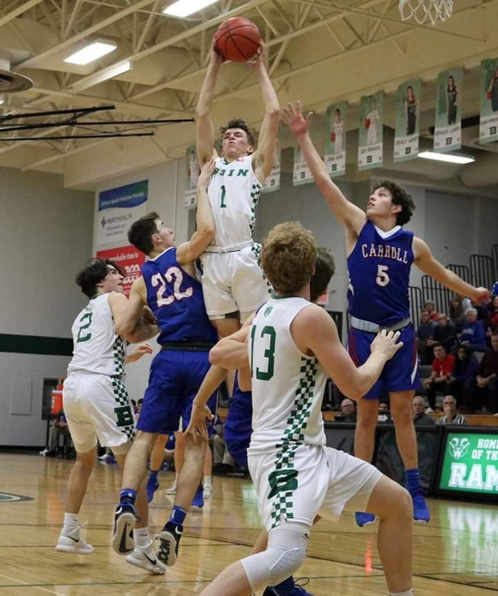 Badin’s Joseph Walsh (1) soars between Carroll’s Matt Cogan (22) and Will Severt (5) during Friday night’s game at Mulcahey Gym in Hamilton. Badin won 43-42. CONTRIBUTED PHOTO BY TERRI ADAMS