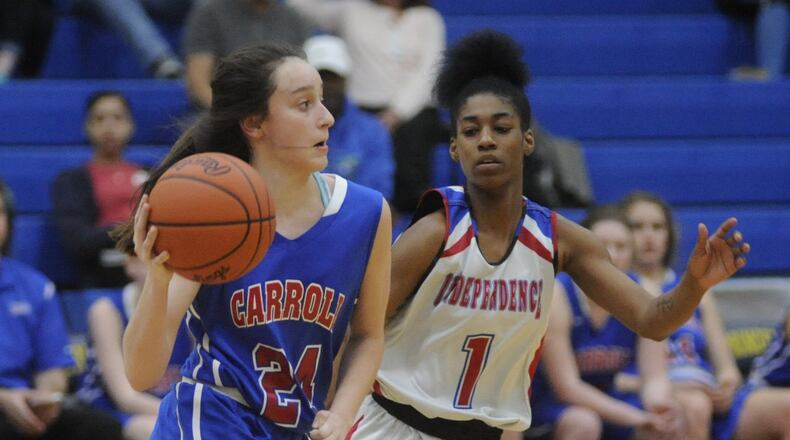 Carroll’s Allie Stefanek (left) is checked by Carlisa Strickland of Columbus Independence during a Division II regional semifinal at Springfield on March 7, 2017. Carroll won 68-45. MARC PENDLETON/STAFF