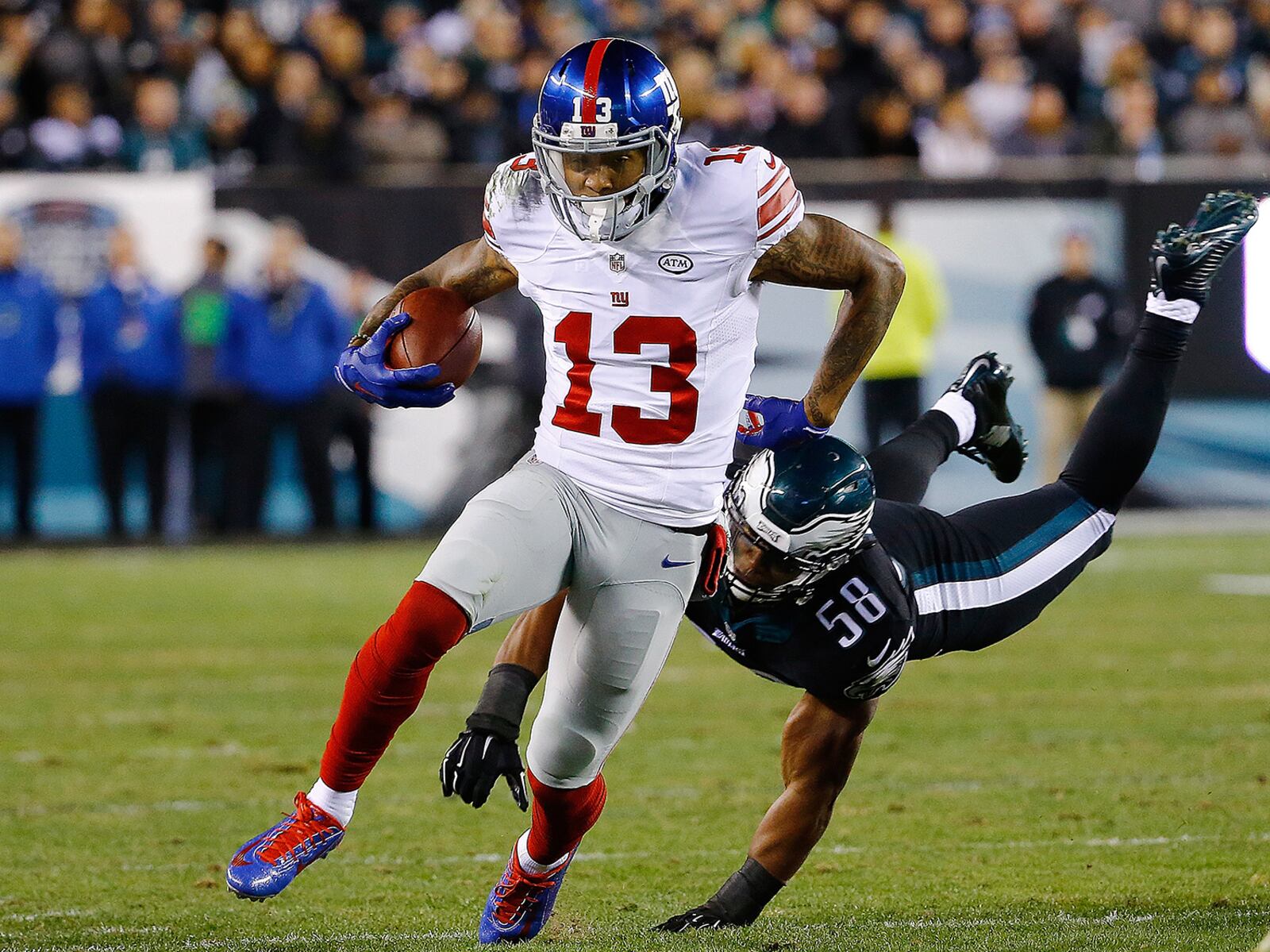 PHILADELPHIA, PA - OCTOBER 19: Odell Beckham #13 of the New York Giants avoids the tackle attempt by Jordan Hicks #58 of the Philadelphia Eagles during the first quarter at Lincoln Financial Field on October 19, 2015 in Philadelphia, Pennsylvania. (Photo by Al Bello/Getty Images)