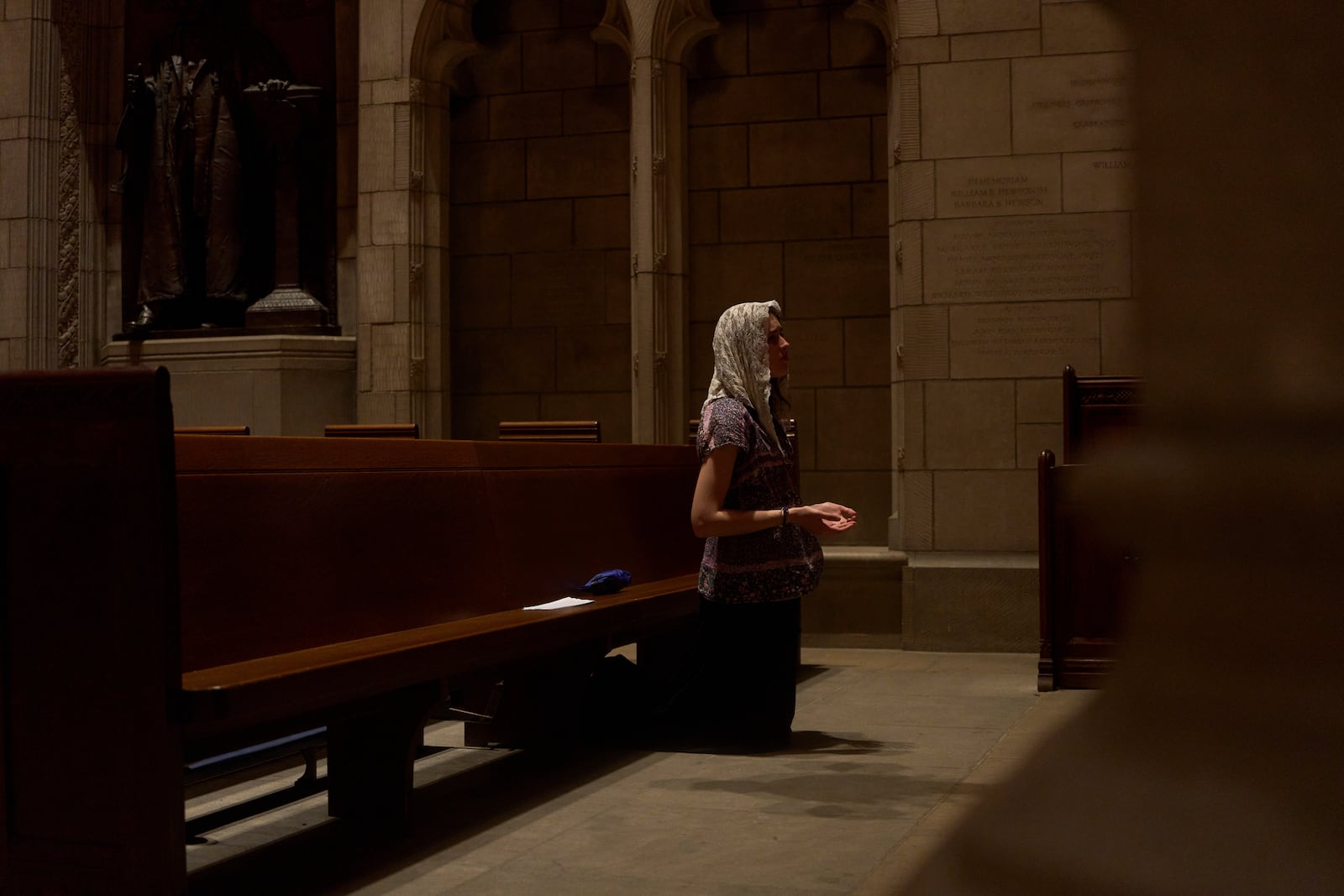 Savannah Nichols, visiting her boyfriend, altar server David Kim, from Ohio, prays after a service at the Princeton University chapel in Princeton, N.J., on Friday, May 16, 2025. (AP Photo/Luis Andres Henao)
