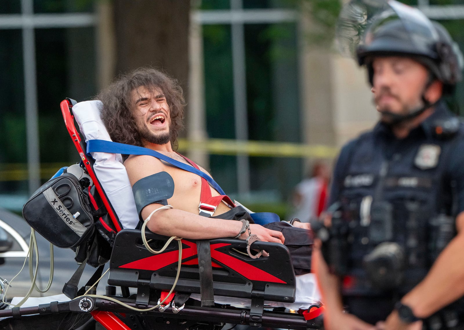 Arturo Gamboa is taken away in handcuffs on a gurney during the “No Kings” protest in Salt Lake City on Saturday, June 14, 2025. (Scott G. Winterton/The Deseret News via AP)