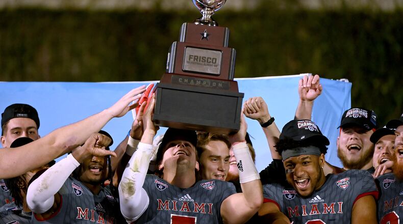 Miami (Ohio) quarterback Brett Gabbert holds up the championship trophy after the team's 27-14 win over North Texas in the Frisco Football Classic NCAA college football game in Frisco, Texas, Thursday, Dec. 23, 2021. (AP Photo/Matt Strasen)