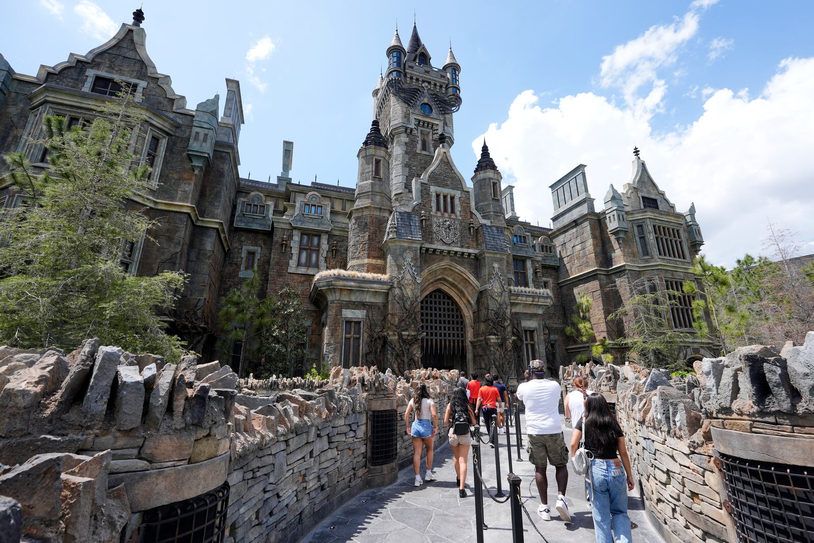 Guests enter the The Frankenstein Castle in Dark Universe at Epic Universe Theme Park at Universal Resort Orlando Thursday, April 10, 2025, in Orlando, Fla. (AP Photo/John Raoux)