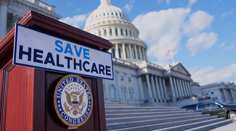 FILE - A podium is prepared before Democrats hold news conference on the health care funding fight on the steps of the House before votes to end the government shutdown on Capitol Hill, Nov. 12, 2025, in Washington. (AP Photo/Mariam Zuhaib, File)