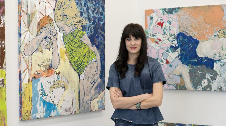 Oakwood artist Mychaelyn Michalec with her works: L-R: “Erasing and being erased" in 2016, Acrylic on canvas, 40”. x 40”; “Maarten and his dream of horses,” 30” x 40”, acrylic on canvas. Michalec was one of 75 artists in Ohio to win an award and $4,000 in funding from the Ohio Arts Council. CONTRIBUTED IMAGE BY MARK REAMY