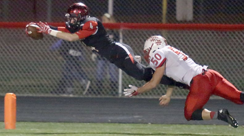 Franklin’s Noah Kremer dives into the end zone for a touchdown, ahead of the tackle attempt by Tippecanoe’s Matt Garber, after blocking a punt during their Division III, Region 12 playoff game at Veterans Memorial Field in Franklin last Saturday night. Kremer helped the Wildcats advance with a 41-40 victory. CONTRIBUTED PHOTO BY E.L. HUBBARD