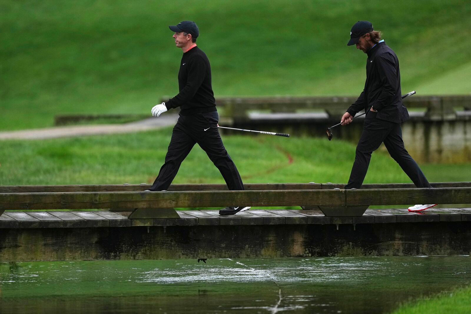 Rory McIlroy, left, of Northern Ireland, and Tommy Fleetwood, of England, walk on the 13th hole during the second round of the Truist Championship golf tournament at the Philadelphia Cricket Club, Friday, May 9, 2025, in Flourtown. (AP Photo/Matt Rourke)