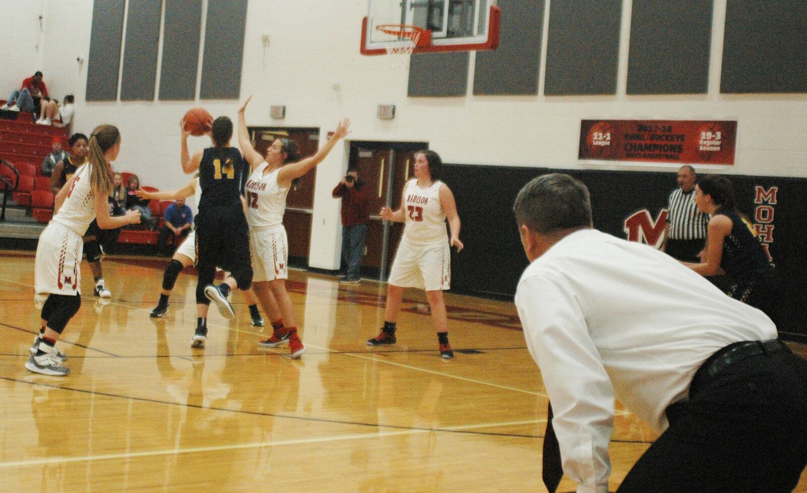 Madison coach Brian McGuire watches intently as Keri Wheeler (12) defends a shot attempt by Monroe’s Sophie Sloneker (14) during Thursday night’s game at Madison. Monroe won 50-39. RICK CASSANO/STAFF