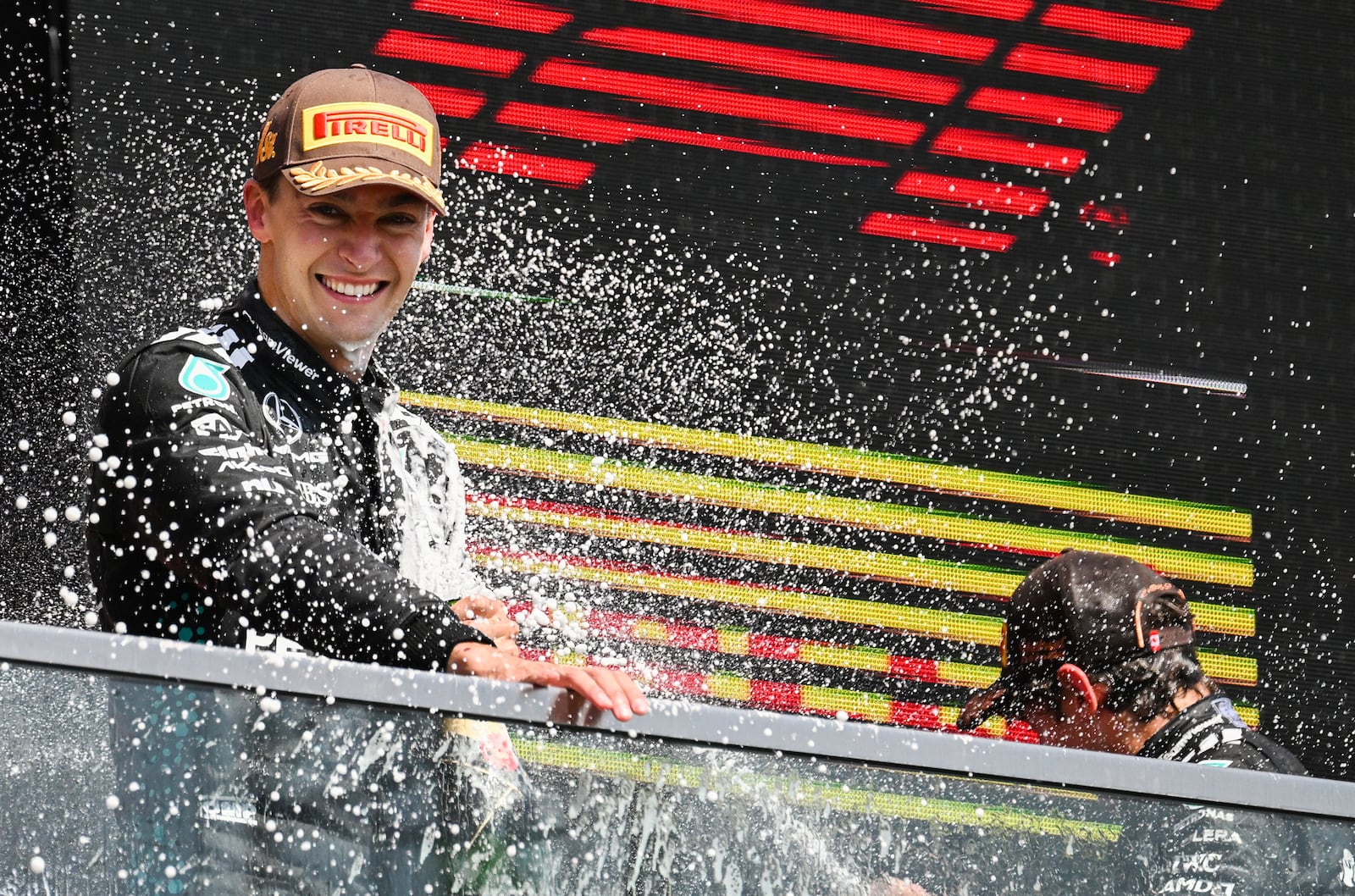 Mercedes driver George Russell, left, of the United Kingdom, left, is sprayed by teammate Kimi Antonelli, right, of Italy, after winning the F1 Canadian Grand Prix auto race in Montreal, Sunday, June 15, 2025. (Graham Hughes/The Canadian Press via AP)