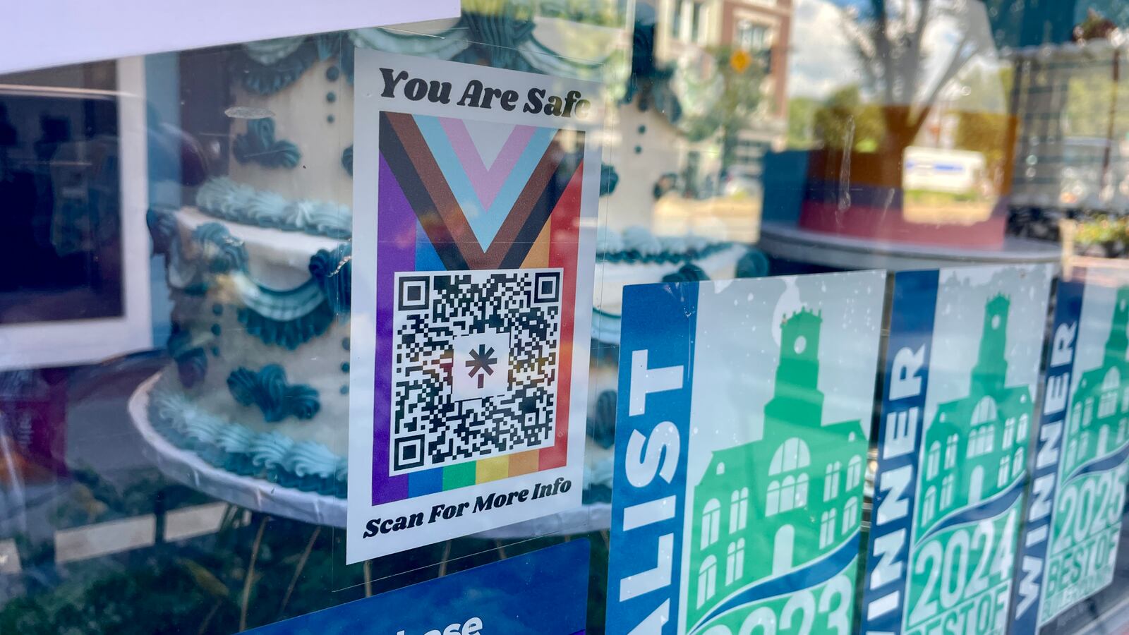Joan Trent (they/them) started a push to highlight safe places for marginalized groups, such as LGBTQ+, minorities, etc. Pictured is the You Are Safe Hamilton decal at Luke's Custom Cakes on High Street in downtown Hamilton. It has a QR code to help people find those businesses and organizations committed to be a safe place for marginalized people. MICHAEL D. PITMAN/STAFF