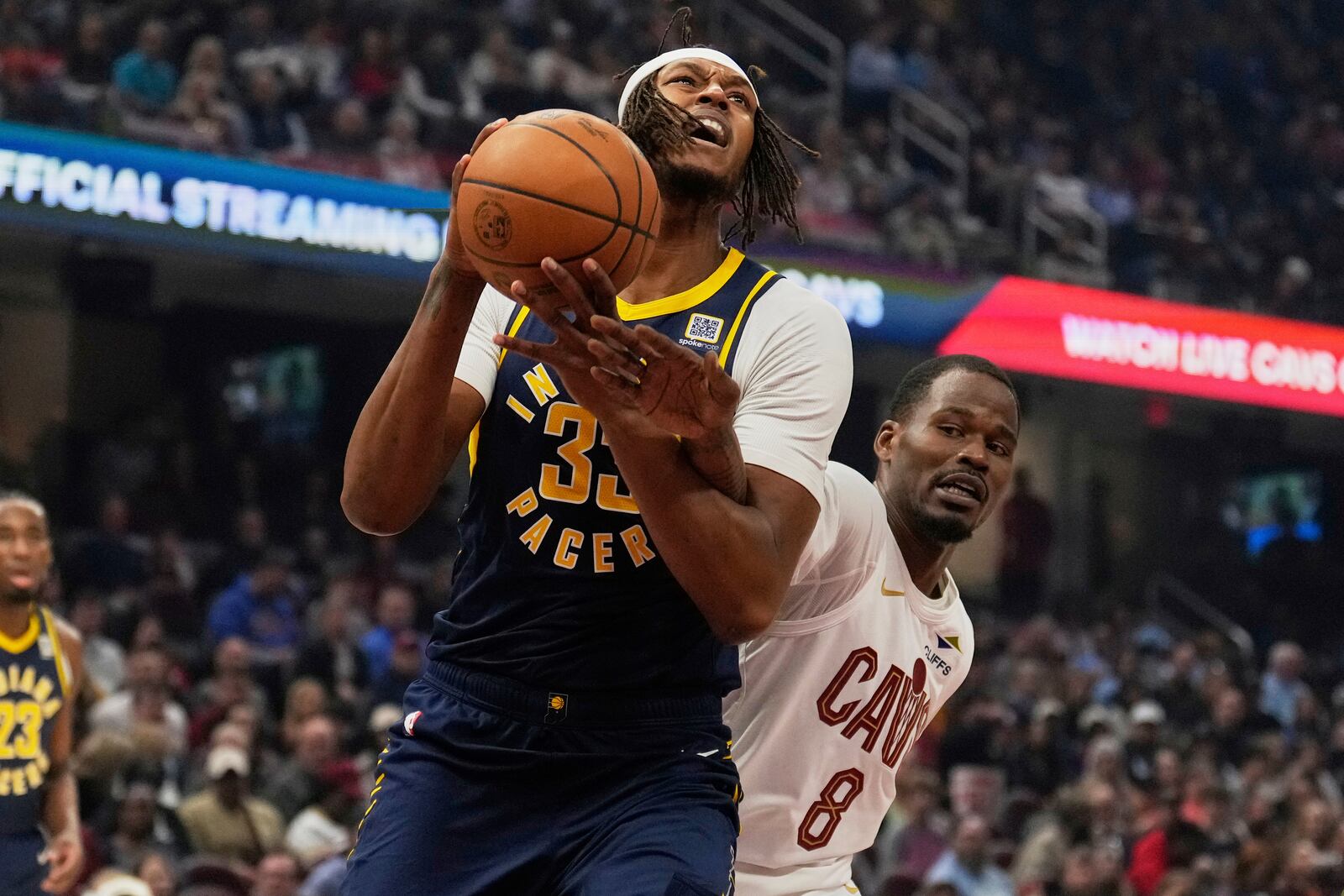 Indiana Pacers center Myles Turner (33) is fouled by Cleveland Cavaliers guard Javonte Green (8) in the first half of an NBA basketball game Sunday, April 13, 2025, in Cleveland. (AP Photo/Sue Ogrocki)