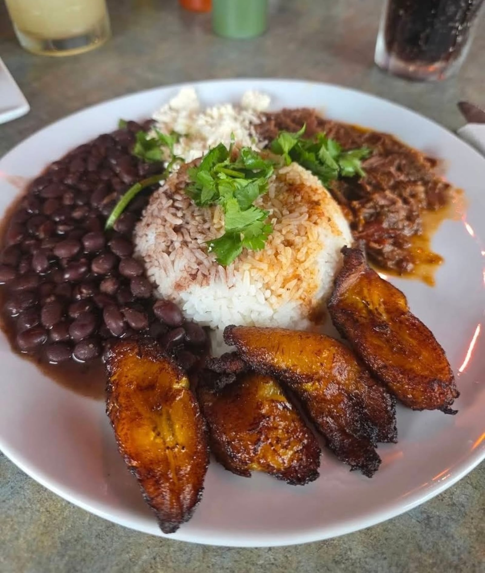 The Pabellón Bowl features rice, black beans, shredded beef, fried plantains and white cheese, a hearty take on Venezuela’s national dish at Latin Arepas Café. ABRAHAM GUERRA/CONTRIBUTED