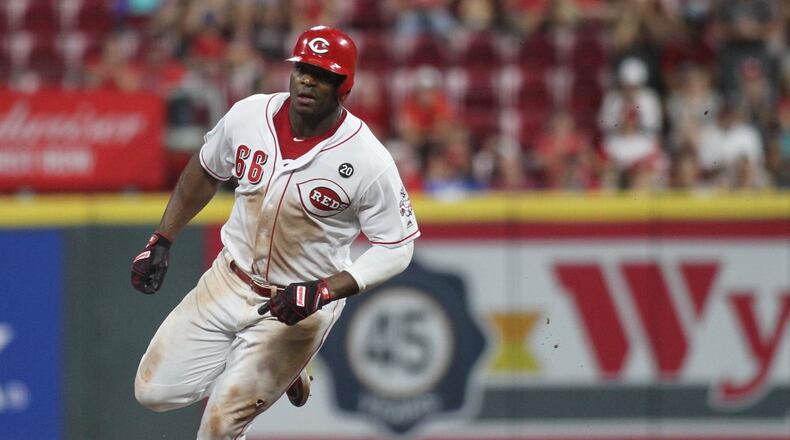 The Reds’ Yasiel Puig rounds the bases on his way to scoring the winning run in the 11th inning against the Brewers on Tuesday, July 2, 2019, at Great American Ball Park in Cincinnati. David Jablonski/Staff
