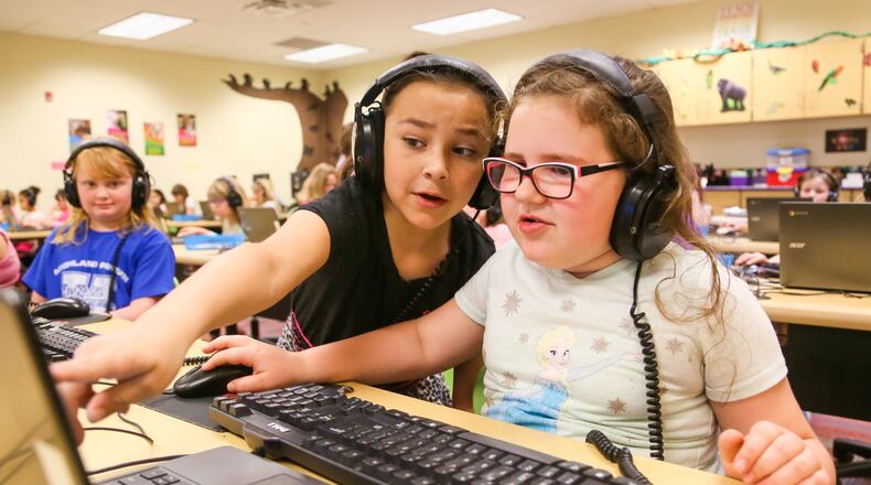 Members of the Highland Elementary Girls Who Code Club, including Esmeralda Martinez and Sophia Overstreet, work on their computers at the school in May. Hamilton City Schools starts a new school year Monday, Aug. 14. GREG LYNCH/STAFF