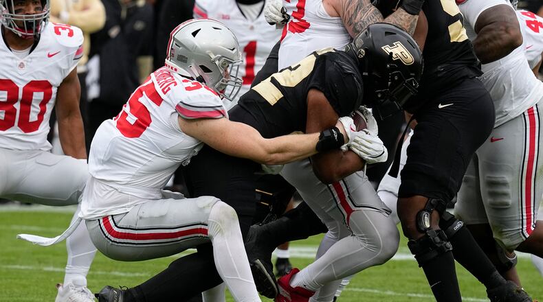 Purdue's Dylan Downing (22) is tackled by Ohio State linebacker Tommy Eichenberg (35) during the first half of an NCAA college football game, Saturday, Oct. 14, 2023, in West Lafayette, Ind. (AP Photo/Darron Cummings)