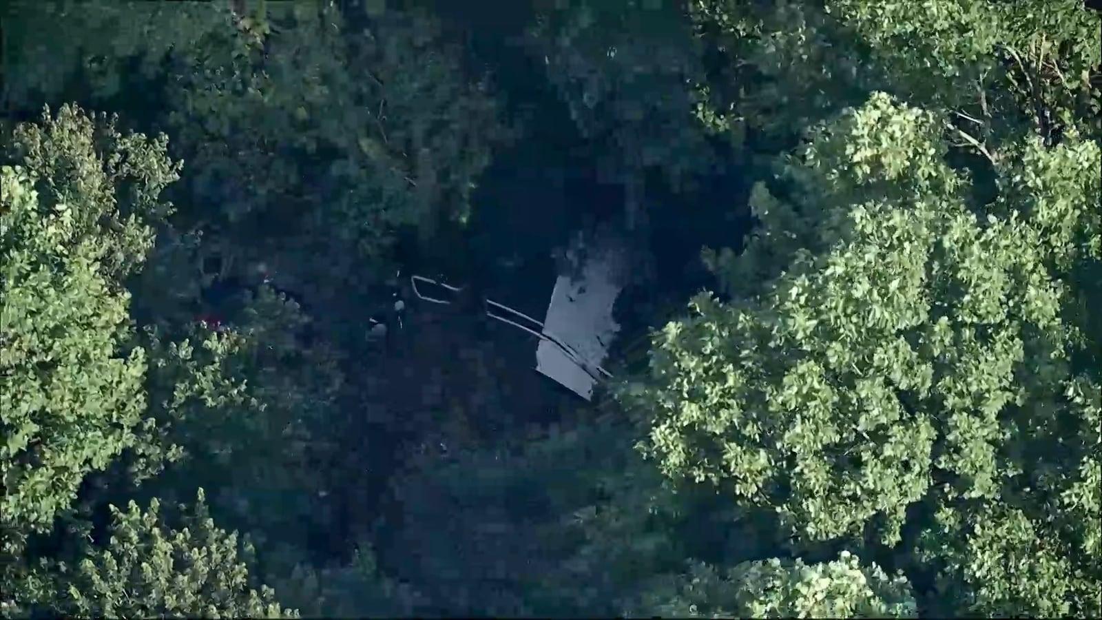 This image taken from video provided by WPVI-TV/6ABC shows a small skydiving aircraft that went off the end of a runway at Cross Keys Airport in Gloucester County, N.J., on Wednesday evening, July 2, 2025. (WPVI-TV/6ABC via AP)