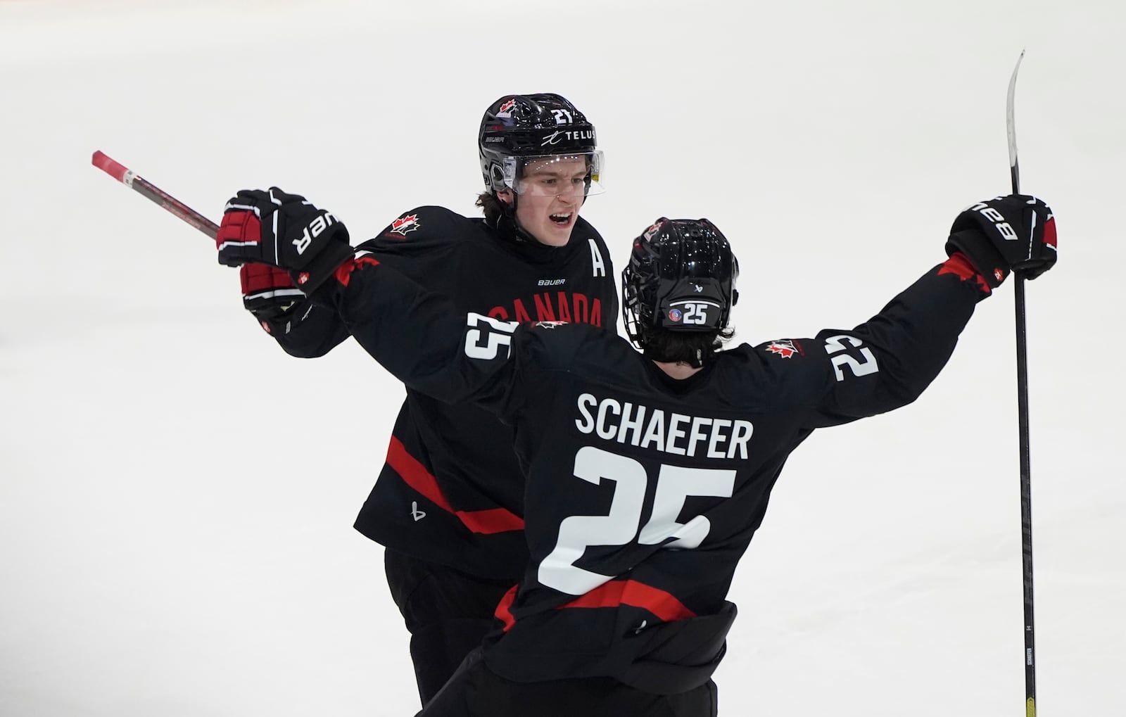 FILE - Canada forward Calum Ritchie, left, celebrates after his goal with defenseman Matthew Schaefer during third-period IIHF World Junior Hockey Championship pretournament action, Dec. 21, 2024, in Ottawa, Ontario. (Adrian Wyld/The Canadian Press via AP, file)