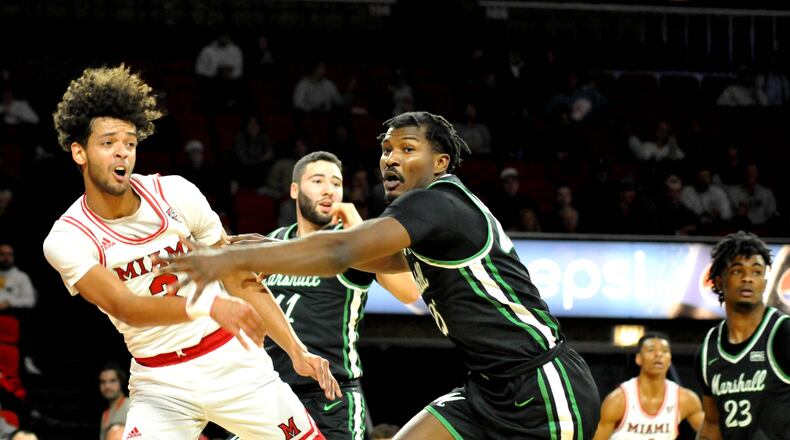 Miami's Julian Lewis, 3, passes the ball off during the first half of a men's basketball game against Marshall at Miami's Millet Hall on Thursday, Nov. 17. DAVID A. MOODIE/CONTRIBUTING PHOTOGRAPHER