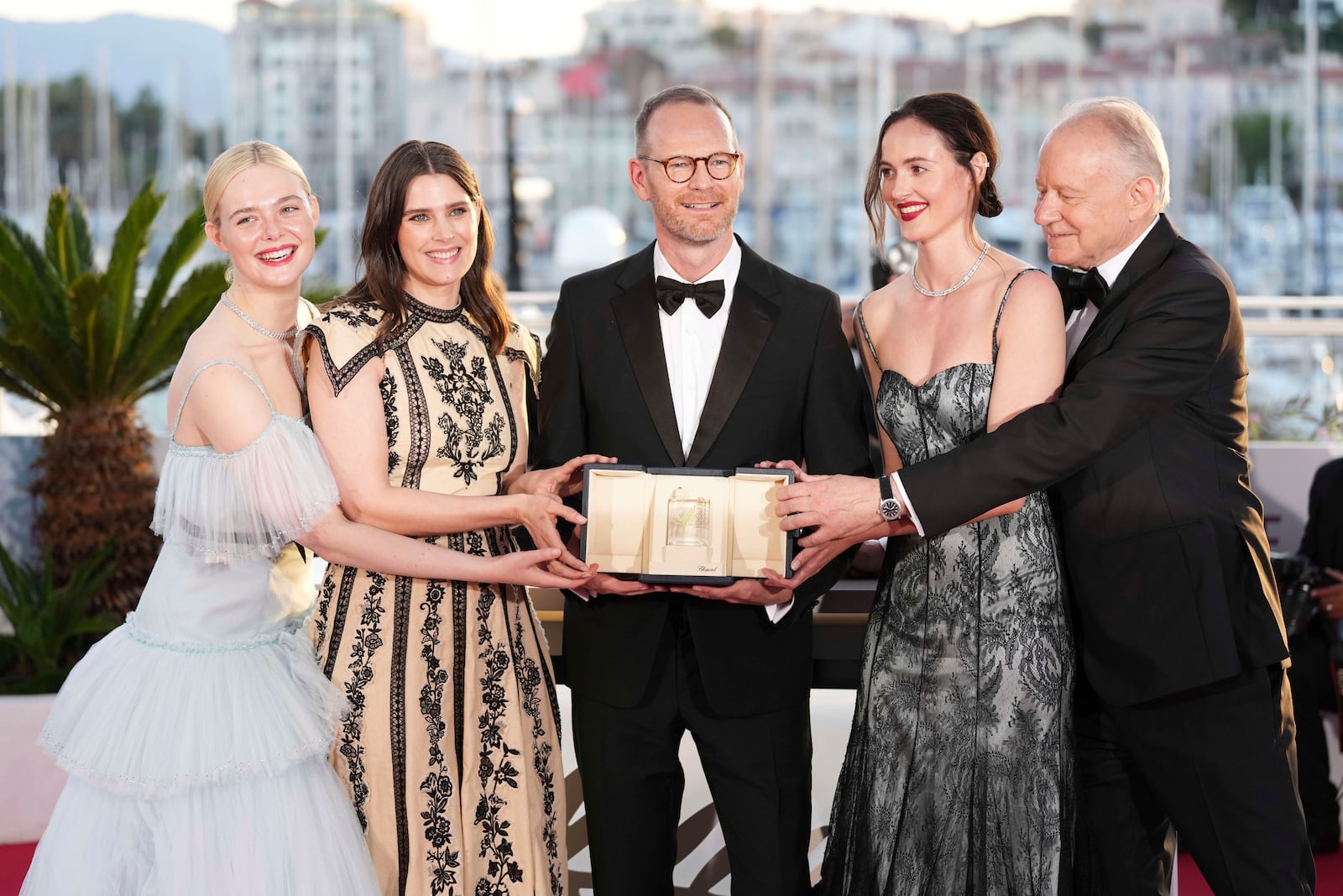 Director Joachim Trier, centre, winner of the grand prix for the film 'Sentimental Value', poses with Elle Fanning, from left, Inga Ibsdotter Lilleaas, Renate Reinsve and Stellan Skarsgard at the awards ceremony photo call at the 78th international film festival, Cannes, southern France, Saturday, May 24, 2025. (Photo by Scott A Garfitt/Invision/AP)