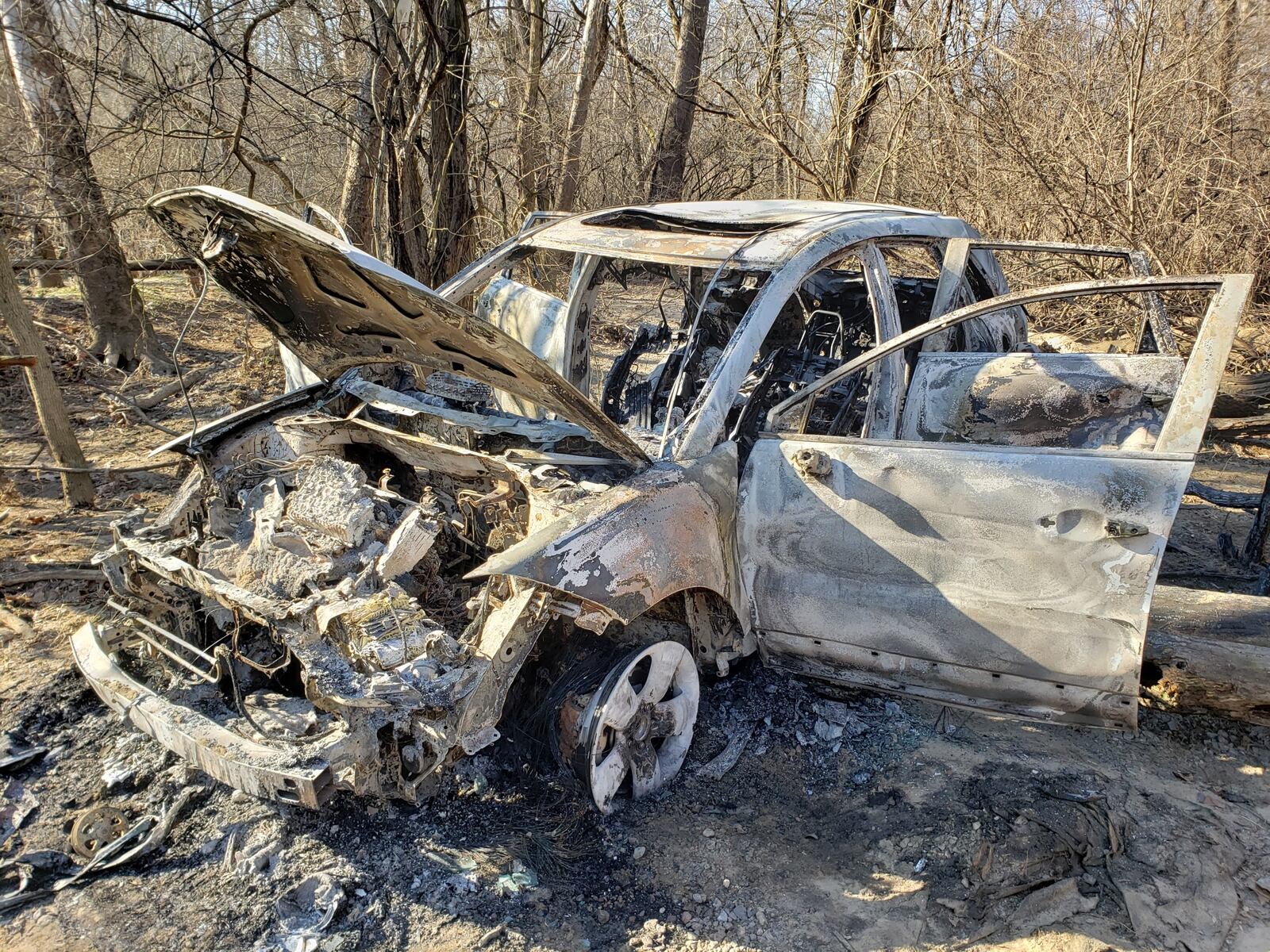 This Acura was found burning at noon Monday in a wooded area behind Amanda Elementary, 1300 Oxford State Road. The car reportedly was stolen Monday morning, according to the Butler County Sheriff’s Office. The fire remains under investigation, according to Middletown fire officials. NICK GRAHAM/STAFF