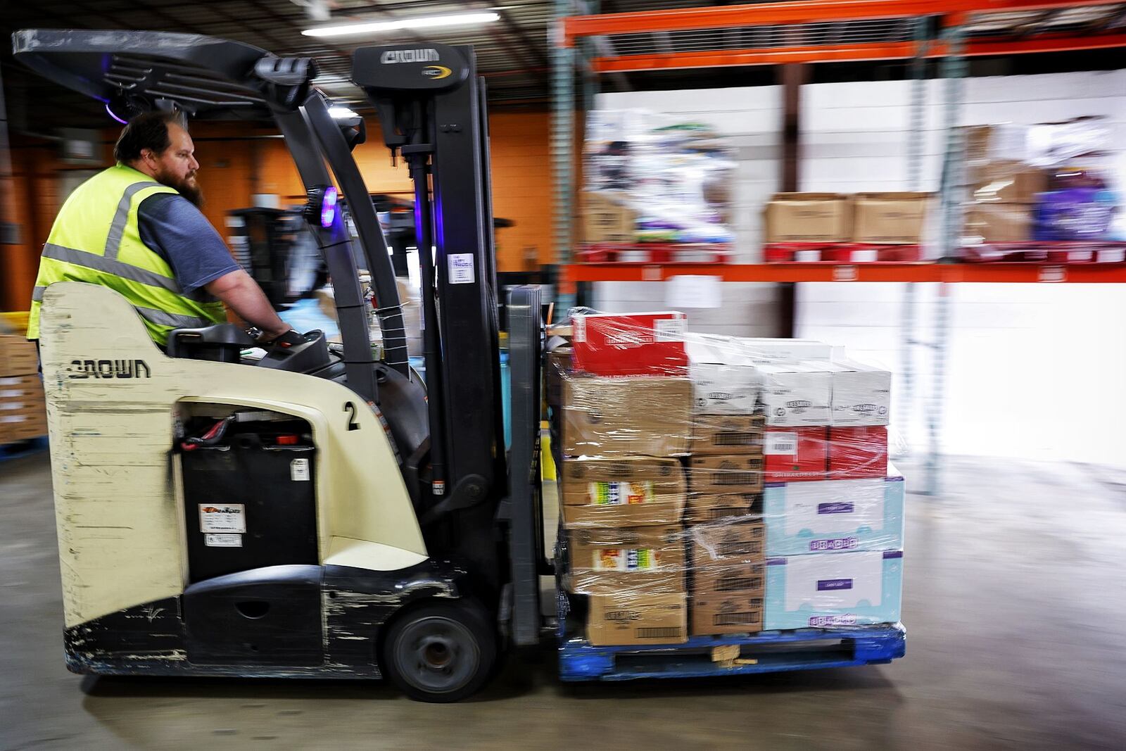 Mike Stamper maneuvers around the warehouse as he loads a truck Tuesday, Oct. 28, 2025 at Shared Harvest Foodbank in Fairfield. NICK GRAHAM/STAFF