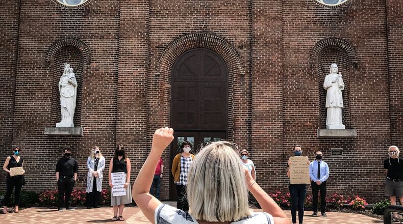 Professors at the University of Dayton held a protest and press conference on the steps of the Immaculate Conception Chapel Tuesday afternoon about the school opening this fall. JIM NOELKER/STAFF
