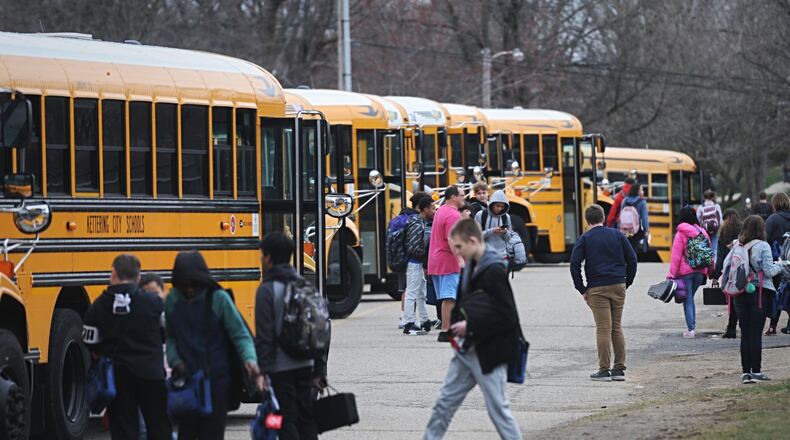 Ohio Gov. Mike DeWine ordered closure of public schools for three weeks, beginning next week, to slow the spread of coronavirus. Here, Kettering students board buses Thursday at Van Buren Middle School. MARSHALL GORBYSTAFF