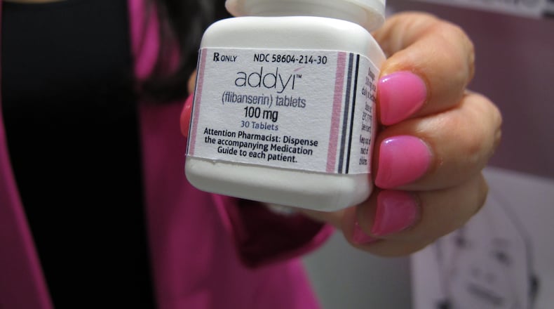 FILE - In this Aug. 18, 2015 file photo, Sprout Pharmaceuticals CEO Cindy Whitehead holds a bottle for the female sex-drive drug Addyi in Raleigh, N.C. (AP Photo/Allen G. Breed, File)