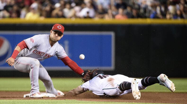 PHOENIX, ARIZONA - SEPTEMBER 13: Tim Locastro #16 of the Arizona Diamondbacks safely steals second base against Jose Iglesias #4 of the Cincinnati Reds during the sixth inning of the MLB game at Chase Field on September 13, 2019 in Phoenix, Arizona. (Photo by Jennifer Stewart/Getty Images)