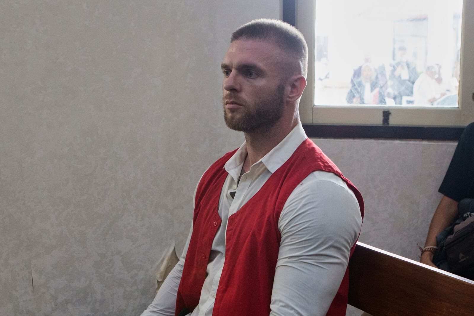 British citizen Thomas Parker, sentenced later for drug offenses, sits on the defendant's chair before the start of his verdict trial at a district court in Denpasar in Bali, Indonesia, Tuesday, May 27, 2025. (AP Photo/Firdia Lisnawati)