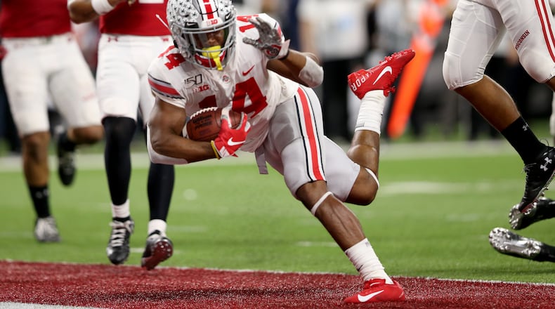 INDIANAPOLIS, INDIANA - DECEMBER 07: K.J. Hill #14 of the Ohio State Buckeyes runs the ball in for touchdown in the Big Ten Championship game against the Wisconsin Badgers during the third quarter at Lucas Oil Stadium on December 07, 2019 in Indianapolis, Indiana. (Photo by Justin Casterline/Getty Images)