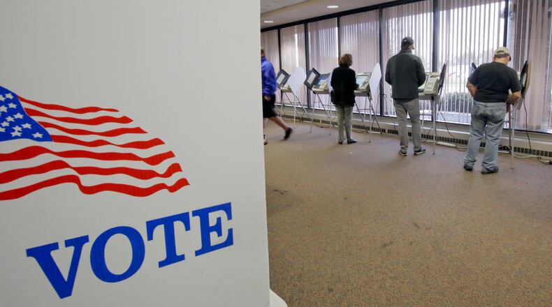 People vote during early voting for the 2016 General Election at the Salt Lake County Government Center on Tuesday, Nov. 1, 2016, in Salt Lake City. Hillary Clinton may not be accumulating the type of early-vote advantage her campaign wanted, but she continues to maintain an apparent edge over Donald Trump, with roughly one-fourth of all expected ballots cast in the 2016 election. (AP Photo/Rick Bowmer)