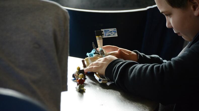 The owners of Coffee Cup Overflowing say the business is struggling to make monthly rent payments. The business is a gathering space for many community groups, such as the Lego Club (pictured). MICHAEL PITMAN/STAFF