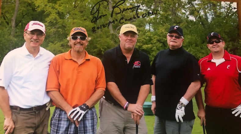 Reds pitcher Tom Browning, center, played in two McCrabb Open charity golf tournaments. He played one hole with each team, including, from left, Rick McCrabb, Rick Post, Mike Schuster and Scott Schuster. Browning later autographed the picture for McCrabb. SUBMITTED PHOTO