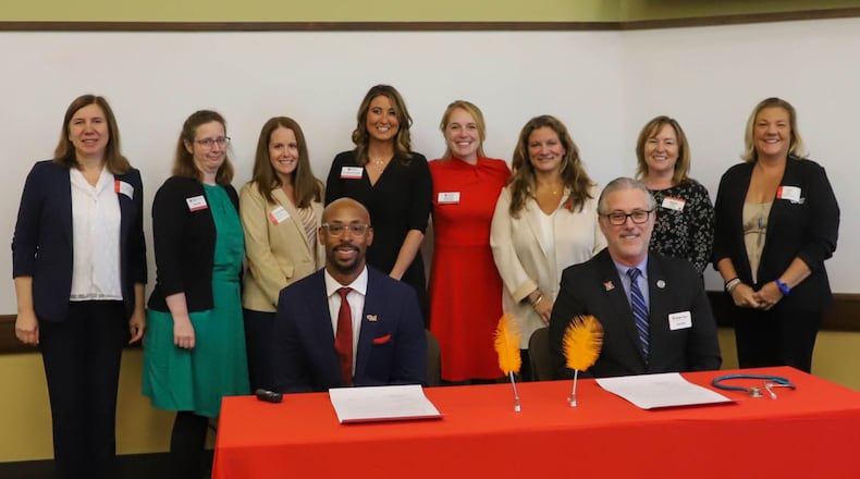 A new partnership between this county’s high school career school system and Miami University’s regional campuses in Hamilton and Middletown will now mean more local teens can earn nursing education credits prior to starting college.
Pictured at table L-R is Ande Durojaiye, vice president of Miami Regionals and dean of the College of Liberal Arts and Applied Science and Jon Graft, superintendent, CEO of Butler Tech at partnership signing ceremony at Miami's VOA Learning Center. (Contributed/Journal-News)