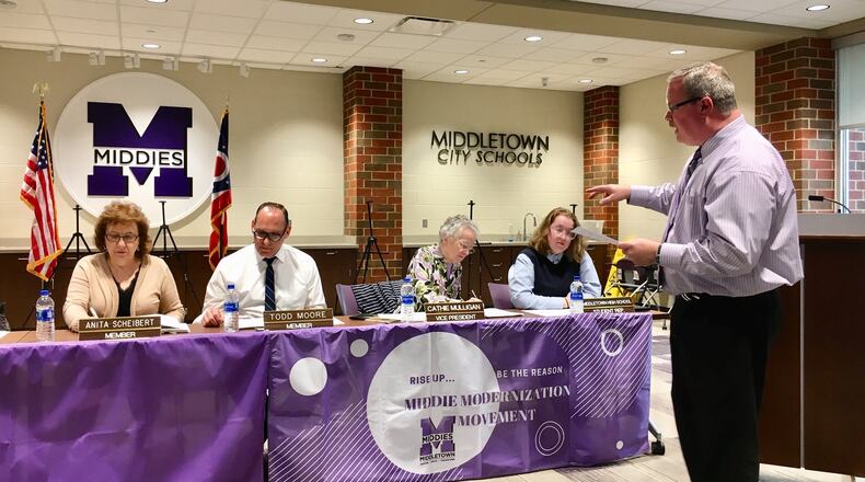 Middletown Schools Treasurer Randy Bertram (right) during Monday’s school board meeting presents a general outline of the district’s five-year financial projections, which are required to be submitted to the state twice a year. Bertram said any projections are problematic now because of the unknown, final version of Ohio’s biennium budget making its way through the Ohio Legislature.