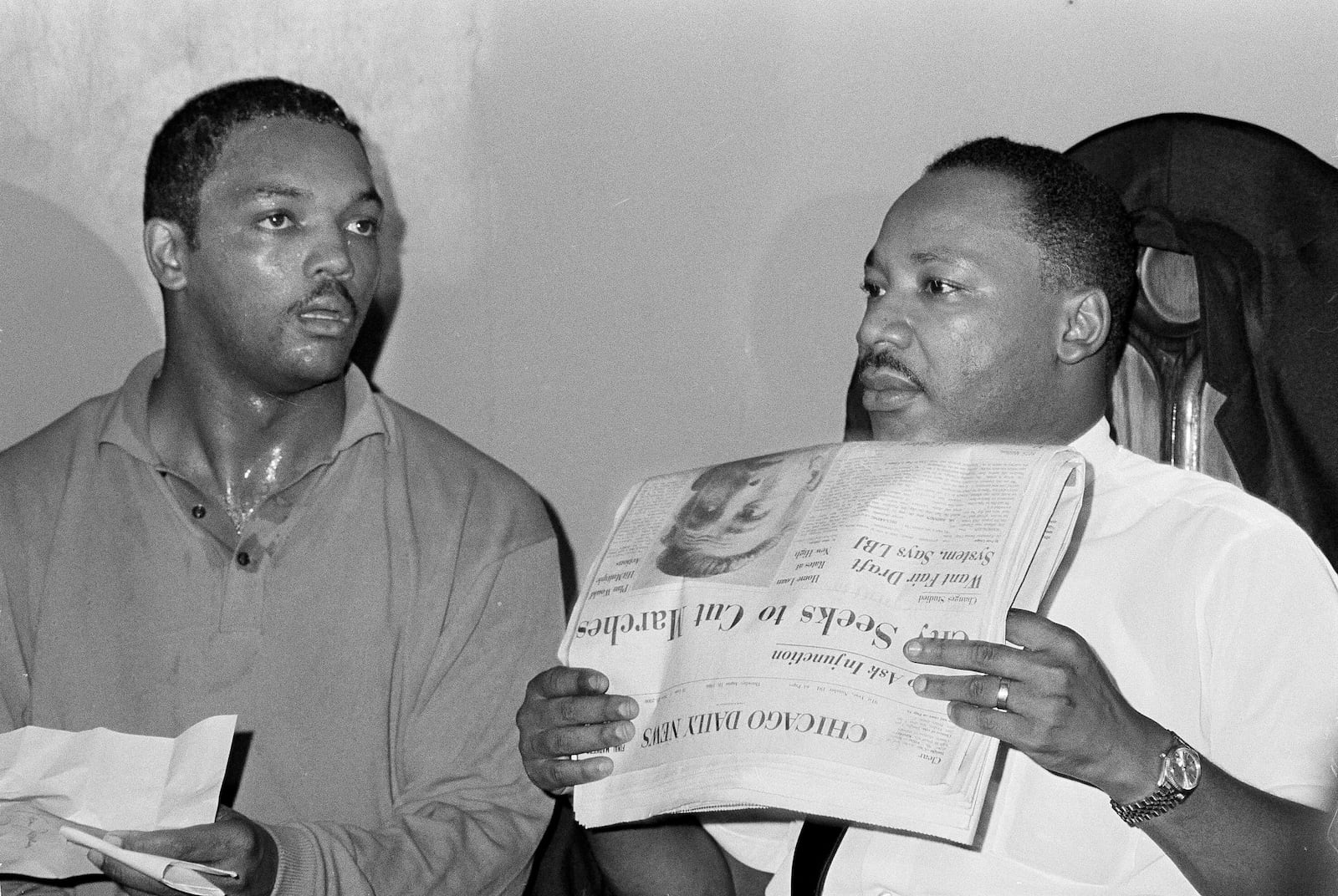 FILE - Civil rights leader Dr. Martin Luther King, Jr., right, and his aide Rev. Jesse Jackson are seen in Chicago, Aug. 19, 1966. (AP Photo/Larry Stoddard, File)