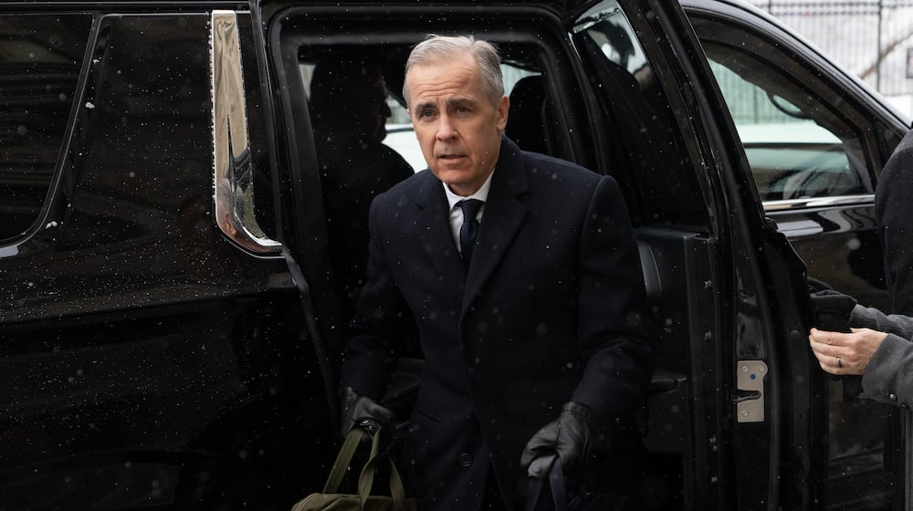 Canadian Prime Minister Mark Carney arrives by motorcade to Parliament Hill in Ottawa, Tuesday, Jan. 27, 2026. (Adrian Wyld/The Canadian Press via AP)