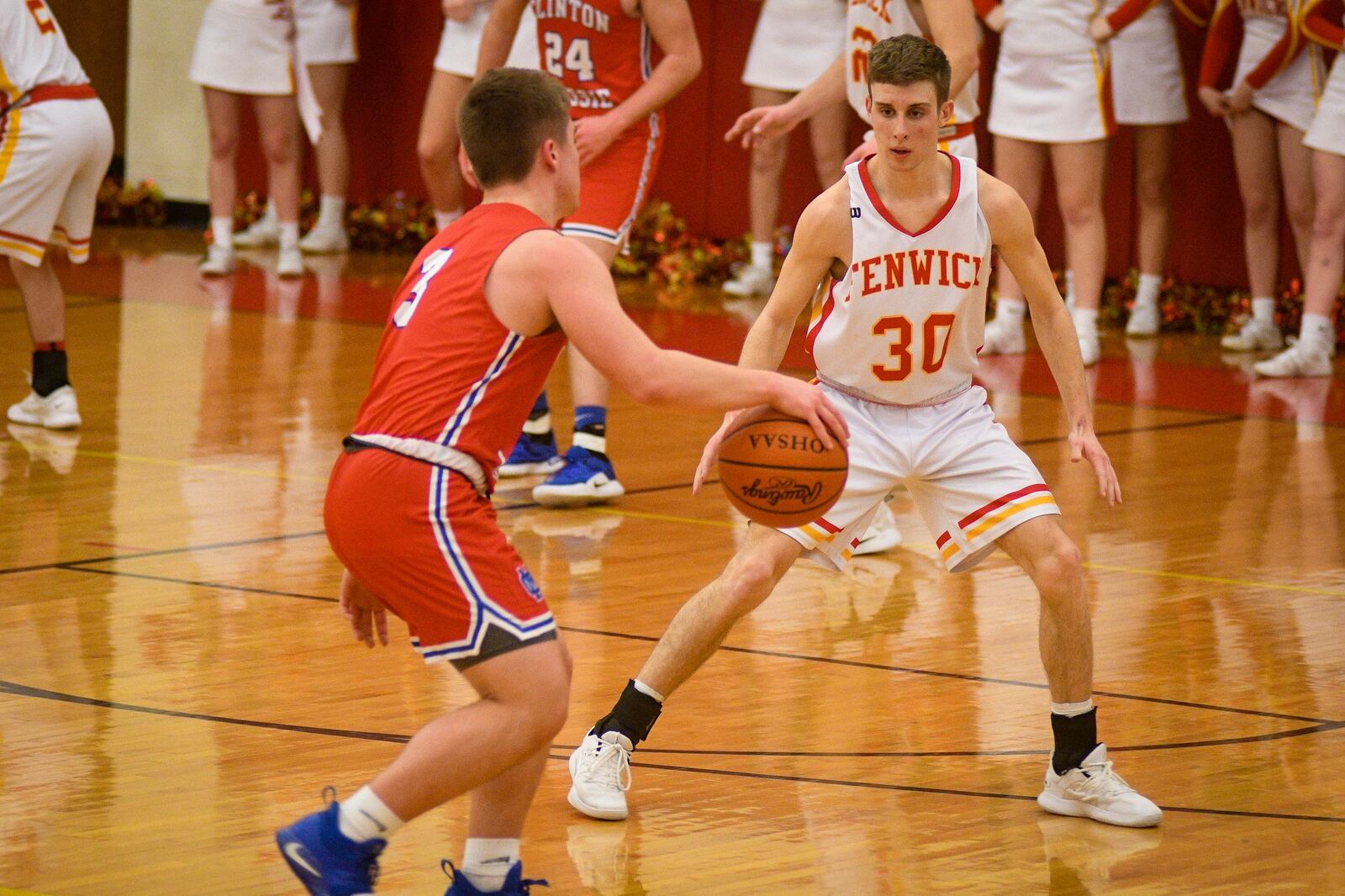 Fenwick’s Travis Dahm (30) defends Brendan Lamb of Clinton-Massie during Monday night’s game at Fenwick. The host Falcons won 67-48. ROB MCCULLEY/RAM PHOTOGRAPHY
