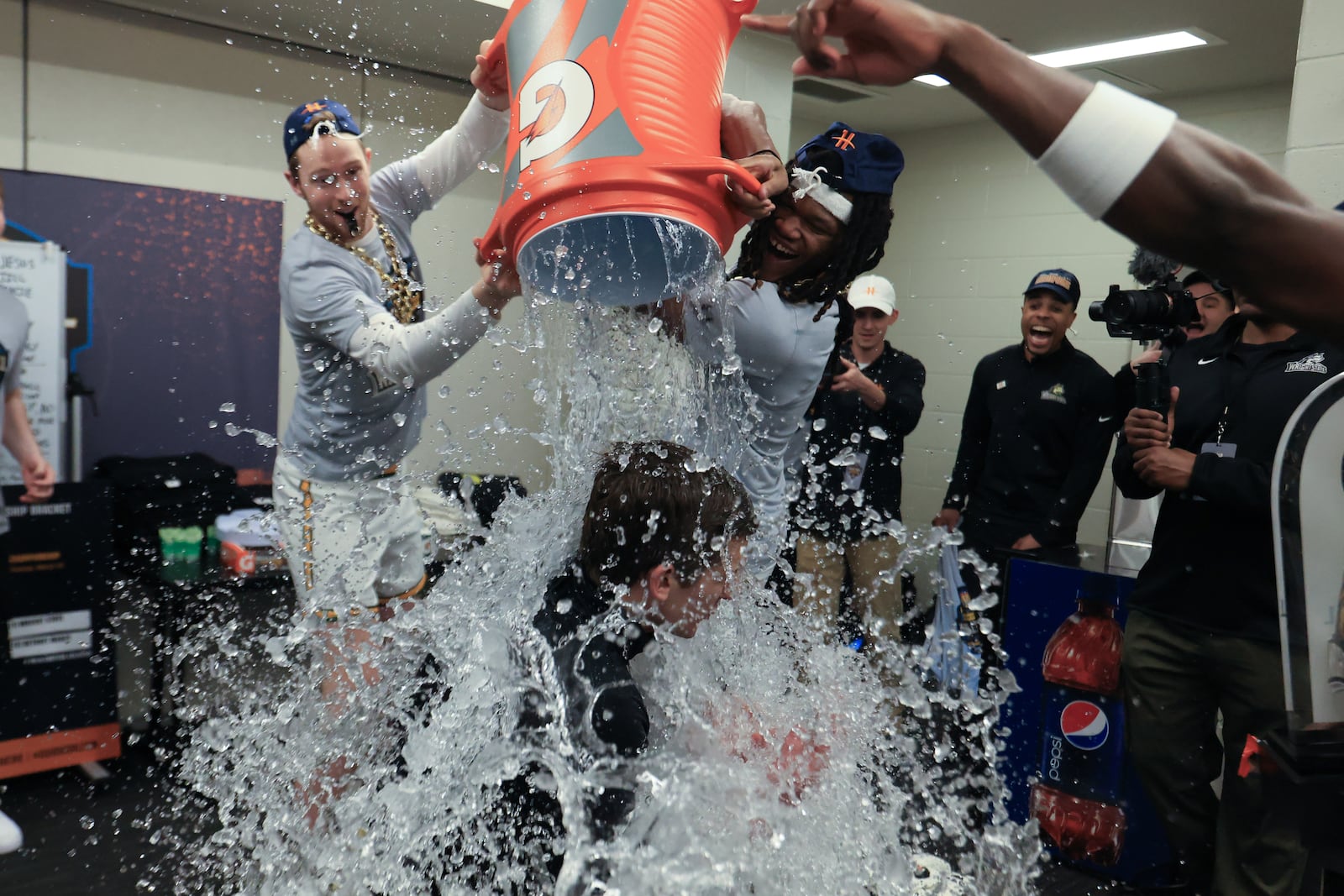 Wright State University players dump water on coach Clint Sargent after beating Detroit Mercy 66-63 to win the Horizon League tournament championship on Tuesday, March 10, 2026 at the Corteva Coliseum in Indianapolis. HORIZON LEAGUE / CONTRIBUTED PHOTO