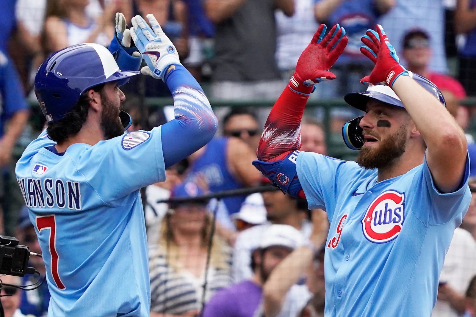 Chicago Cubs' Michael Busch, right, is greeted by Dansby Swanson (7) after hitting a two-run home run against the St. Louis Cardinals during the third inning of a baseball game Friday, July 4, 2025, in Chicago. (AP Photo/David Banks)