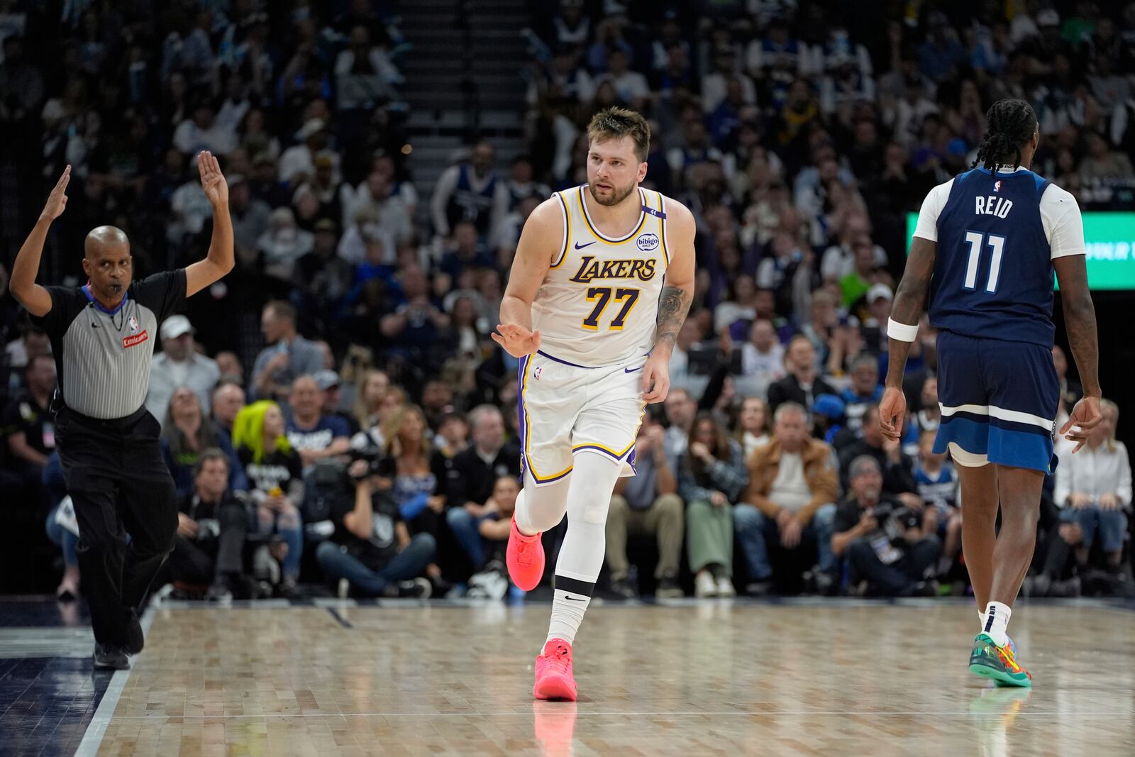 Los Angeles Lakers guard Luka Doncic (77) gestures after making a 3-point basket during the first half of Game 4 of an NBA basketball first-round playoff series against the Minnesota Timberwolves, Sunday, April 27, 2025, in Minneapolis. (AP Photo/Abbie Parr)