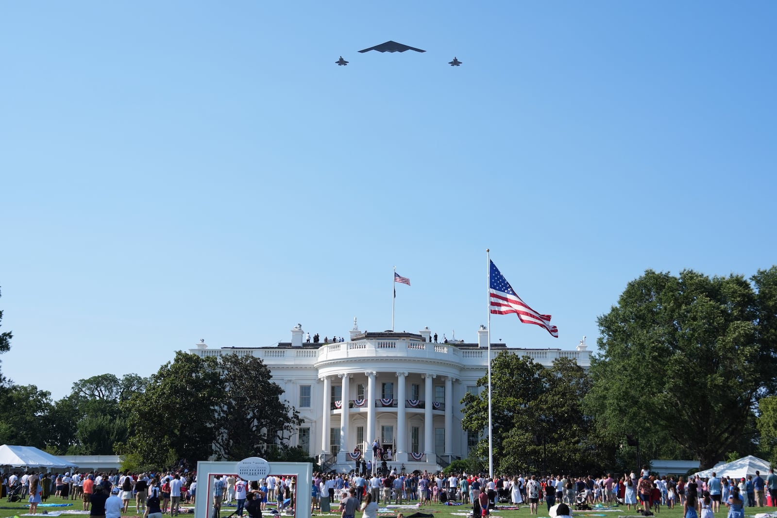 A B-2 bomber and two F-22 fighters conduct a flyover during a Fourth of July celebration at the White House, Friday, July 4, 2025, in Washington. (AP Photo/Evan Vucci)