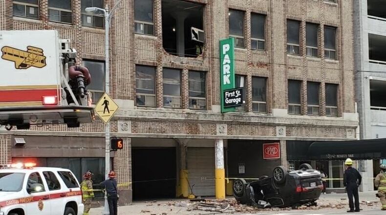 A 53-year-old woman is in stable condition after an SUV she was inside crashed and fell from the second floor of a Dayton parking garage on West First Street Thursday morning. CONTRIBUTED
