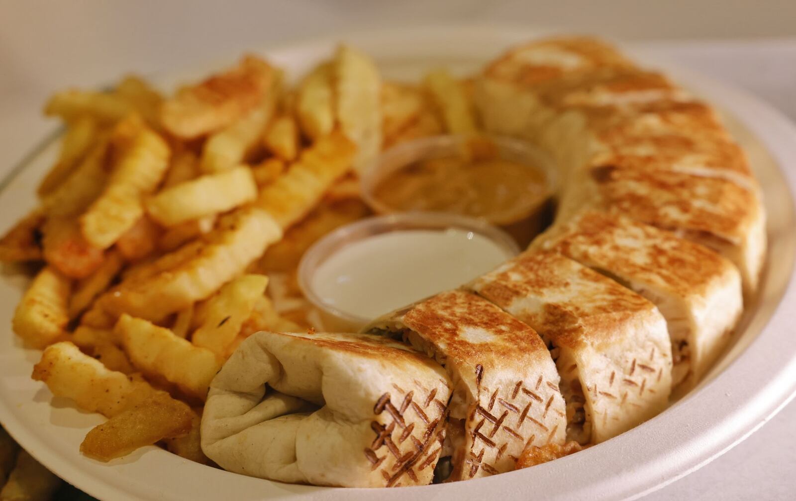 Emad Awad has opened his second location of Symphony Mediterranean Grill inside The Foundry at Liberty Center in Liberty Township. This is their chicken shawarma with fries. NICK GRAHAM/STAFF