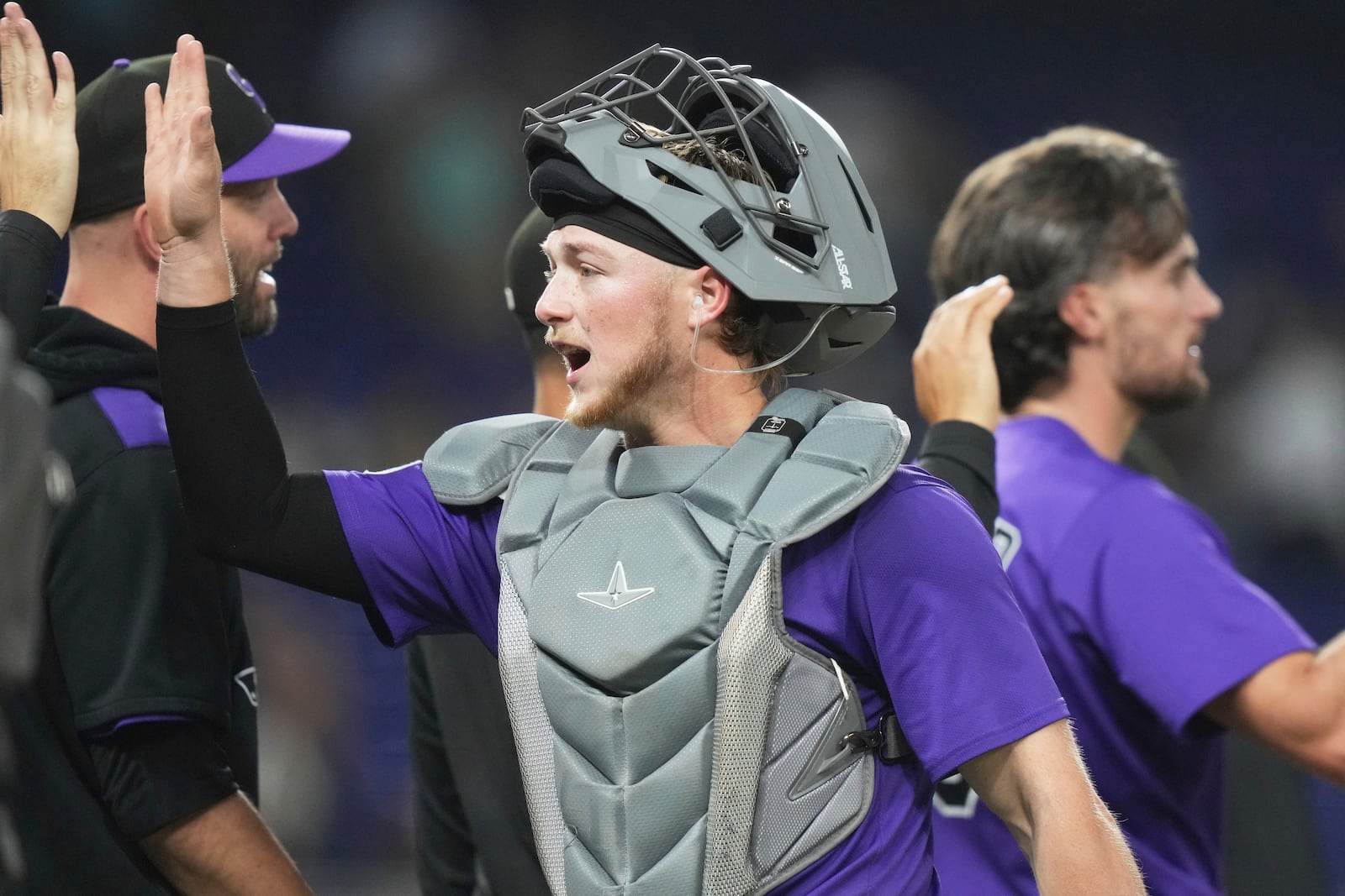 Colorado Rockies catcher Hunter Goodman high-fives with his teammates after the Rockies defeated the Miami Marlins in a baseball game, Tuesday, June 3, 2025, in Miami. (AP Photo/Lynne Sladky)