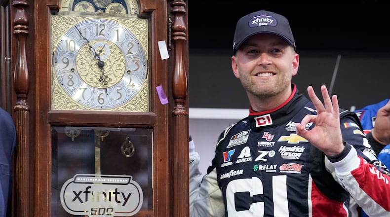William Byron poses with the trophy in Victory Lane after winning a NASCAR Cup series auto race in Martinsville, Va., Sunday, Oct. 26, 2025. (AP Photo/Chuck Burton)