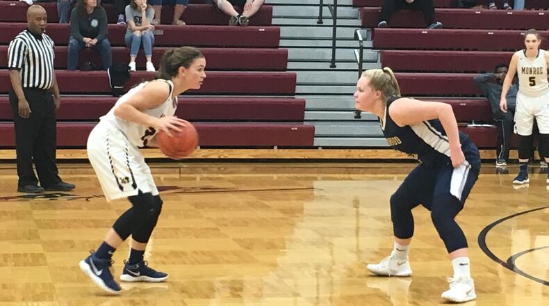Monroe’s Brooke Frazier (left) goes head-to-head with Oakwood’s Abby Duwel (3) during Tuesday night’s Division II sectional semifinal at Lebanon. RICK CASSANO/STAFF