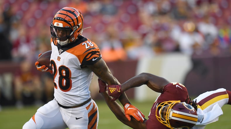 Cincinnati Bengals running back Joe Mixon (28) runs past Washington Redskins cornerback Josh Norman, right, during the first quarter of an NFL preseason football game in Landover, Md., Thursday, Aug. 15, 2019. (AP Photo/Susan Walsh)